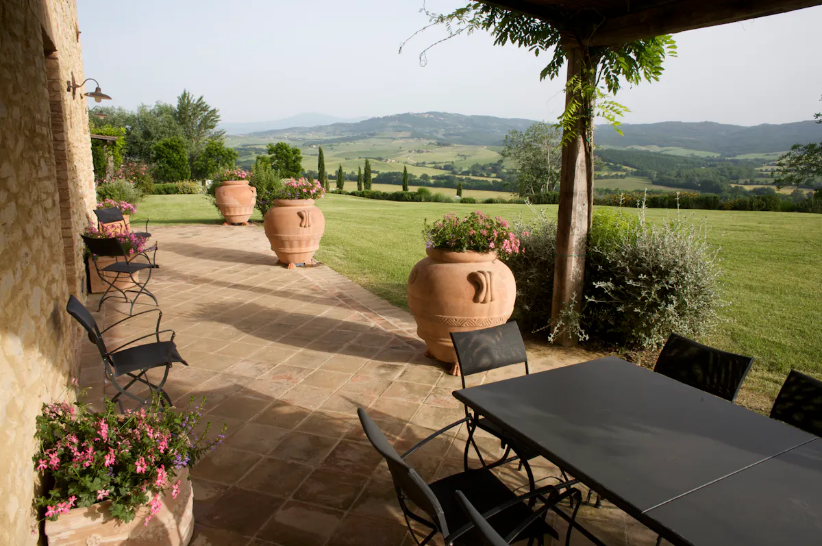 a vase of flowers sitting on a bench